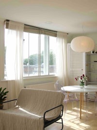 a living room with a dining table and chairs